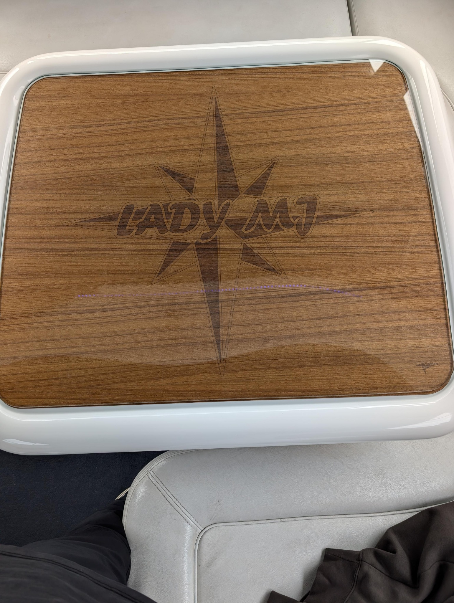 Custom engraved teak panel with a compass design
